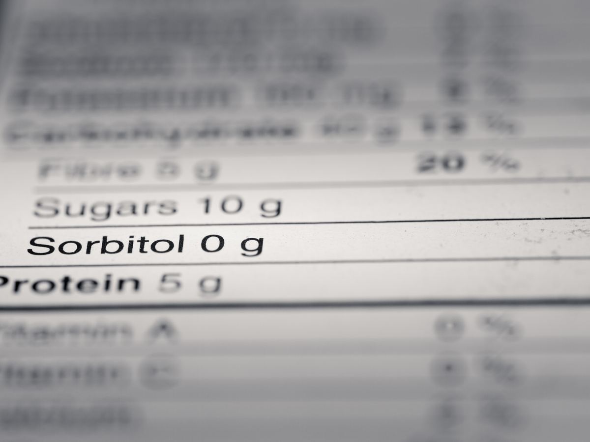 Close-up of nutrition label values showing sugars 10 g and protein 5 g