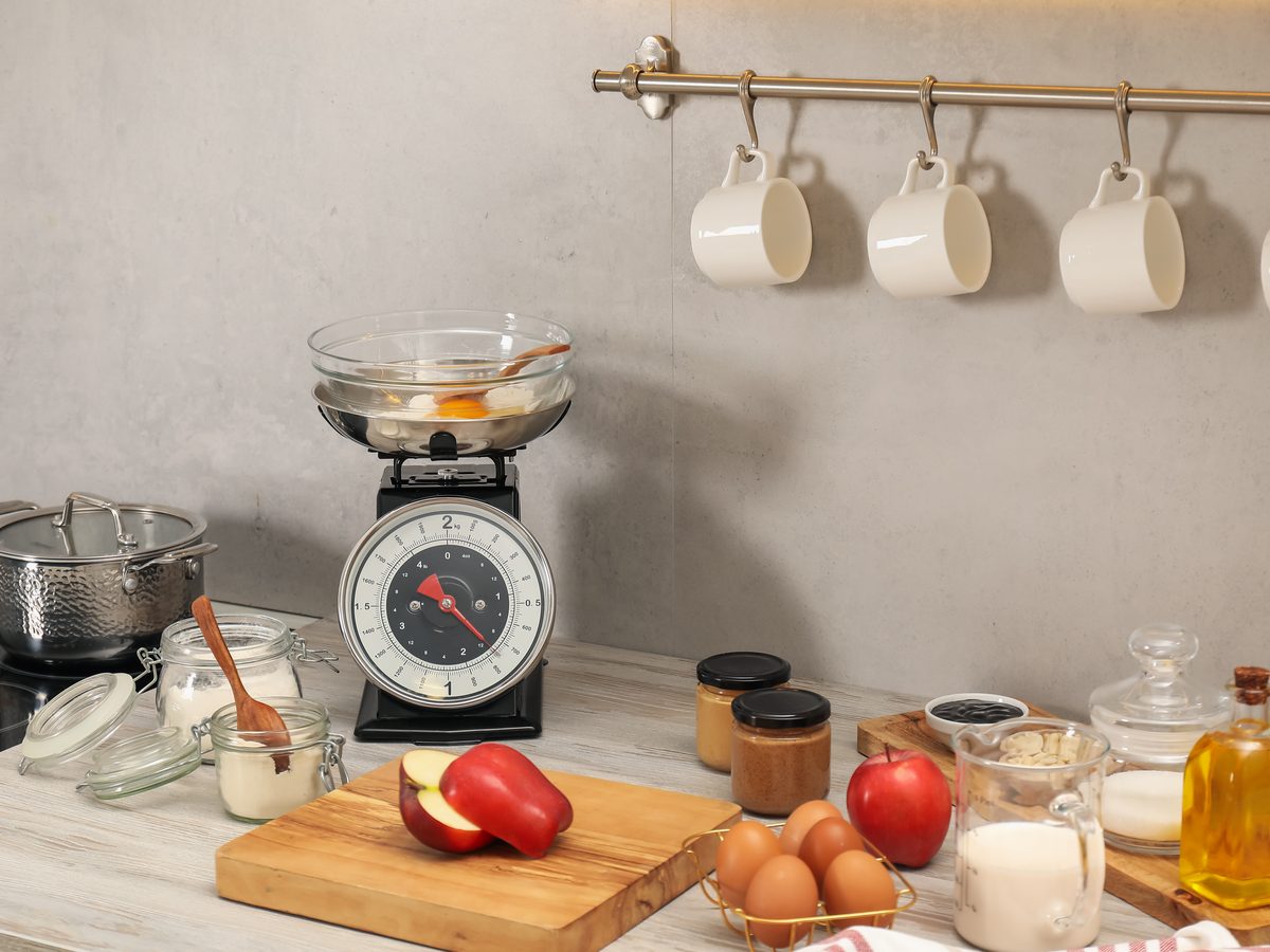 Kitchen scale and baking ingredients on a bright worktop