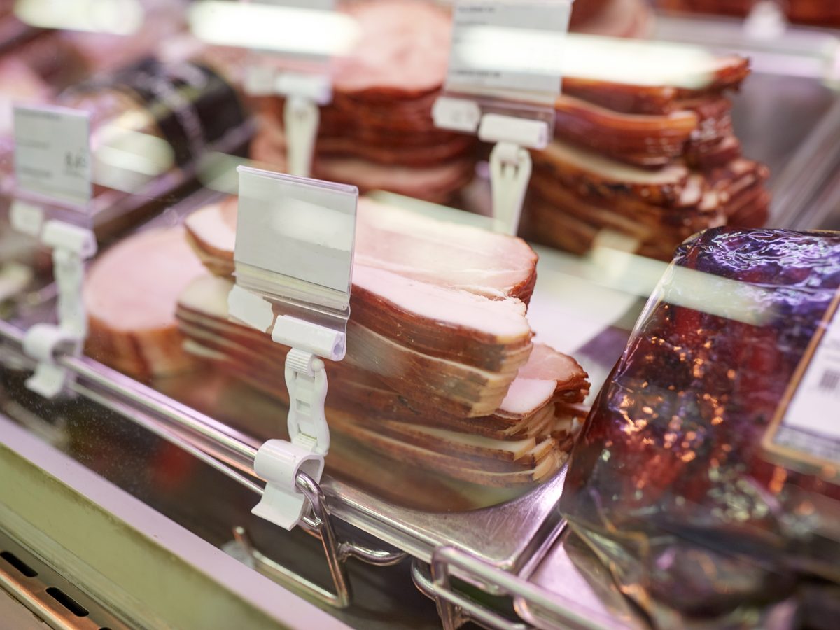 Sliced deli meats in a refrigerated supermarket display case