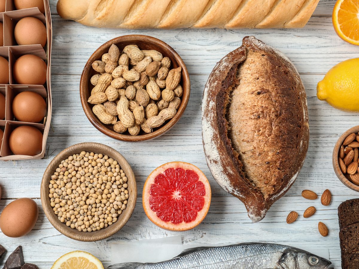 Eggs, pulses, bread and citrus arranged on a rustic wooden surface