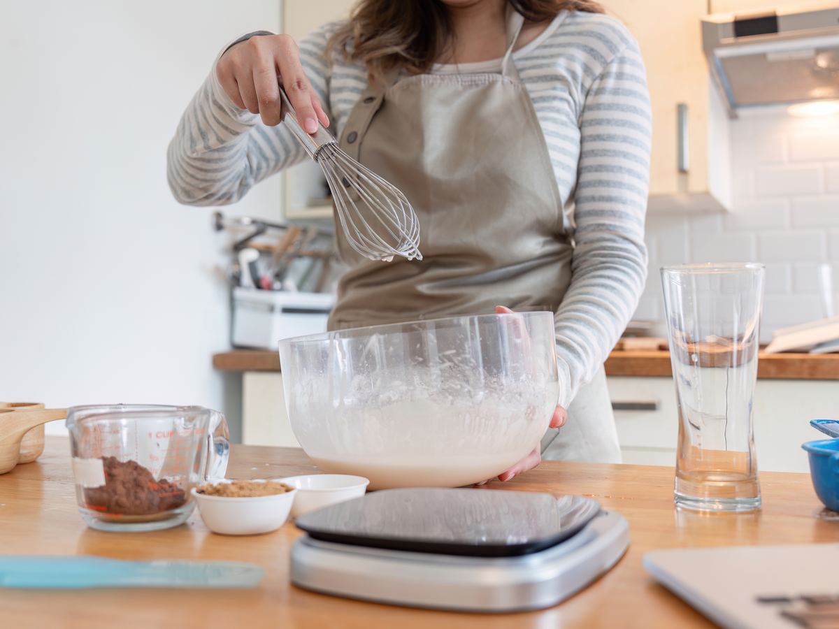 Weighing ingredients on a kitchen scale while preparing a recipe