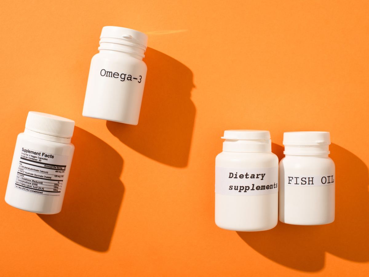 White supplement bottles labelled omega-3, dietary supplements and fish oil
